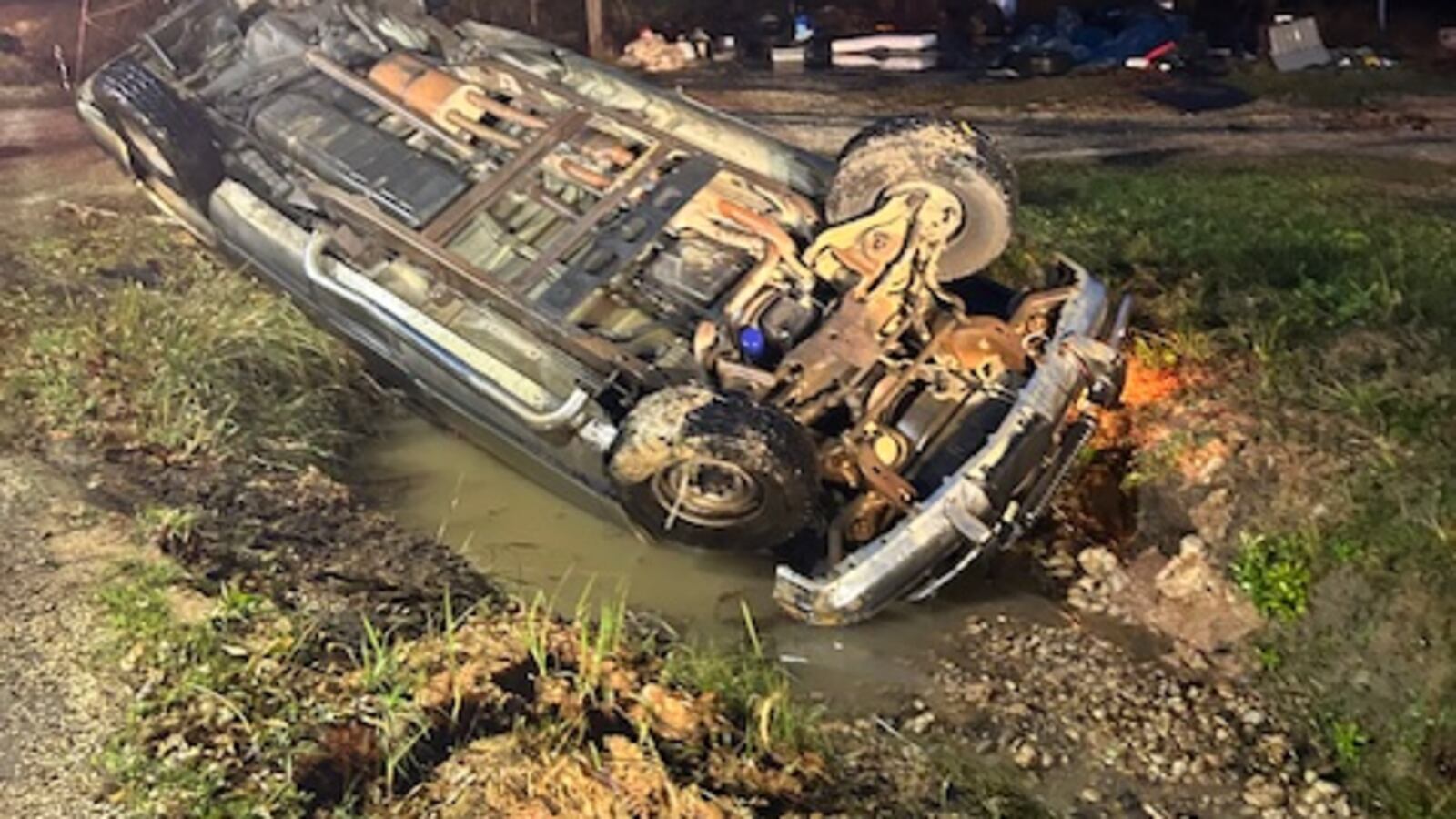 Man Backing Up Man escapes injury after he misses driveway while backing up, flips pickup